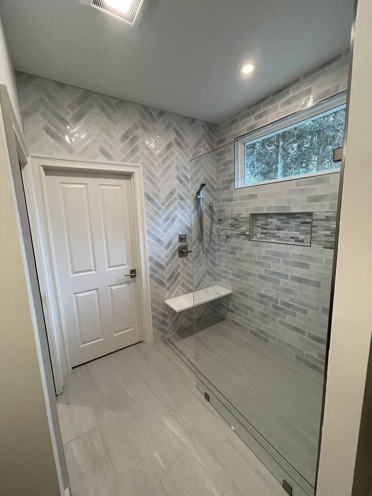 Modern bathroom remodel with new fixtures and tile